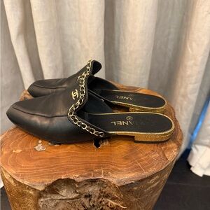 CHANEL black leather mule gold chain detail
